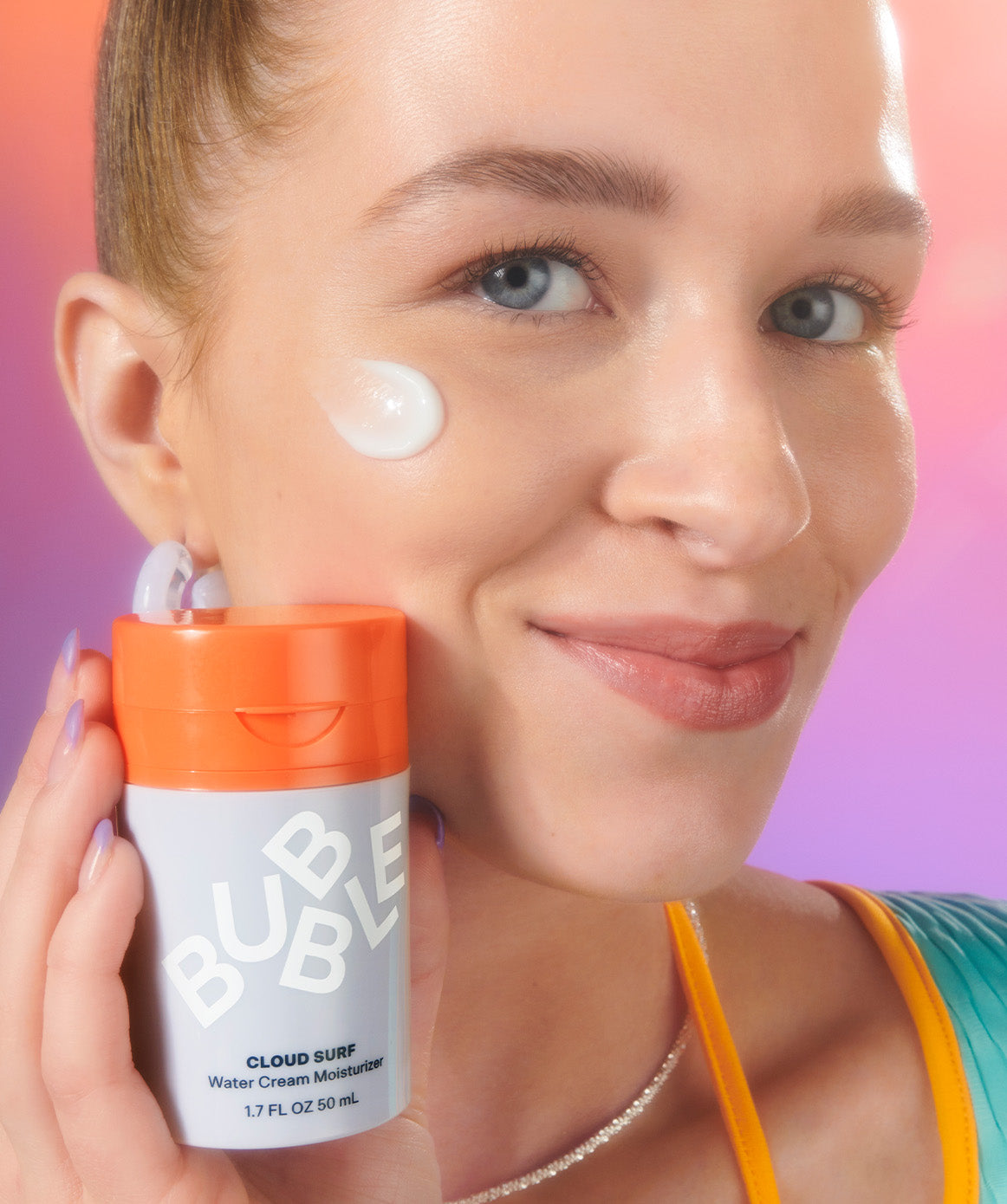 model displaying a bottle of model applying water cream moisturizer